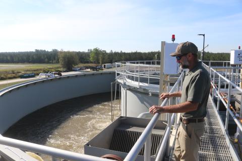 Cody Pridgeon, the City of Lake City’s wastewater director, looks in on a tank of untreated wastewater last year at the North Florida Mega Industrial Park wastewater plant after it began operating. Columbia County’s decision to sell the plant to the city has raised concerns with the North Florida Water Utilities Authority. (FILE)