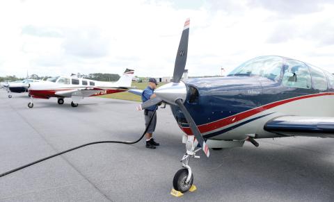 Casey Roach, a lineman at the Lake City Gateway Airport, fuels a Bonanza on Friday afternoon. At least 30 of the Beechcraft airplanes are at the airport practicing for a Wisconsin air show. (TONY BRITT/Lake City Reporter)