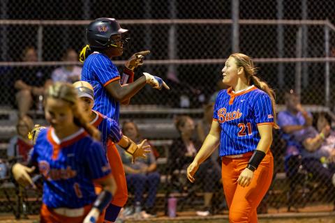 Branford first baseman Mallory Blue (left) celebrates with pitcher Harleigh Price after hitting a three-run home run against Fort White in the District 6-R semifinals on Tuesday. (JACK HOWDESHELL/Lake City Reporter)