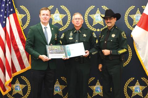 Columbia County Sheriff’s Office Sergeant Sean Sikes (center) receives his certificate after graduating from the Florida Sheriffs Association Commanders Academy from FSA Executive Director Matt Dunagan (left) and Marion County Sheriff Billy Woods, the FSA vice president. (COURTESY)