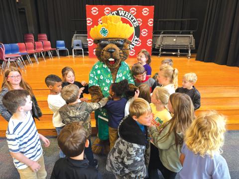 Fort White Elementary School second graders crowd Bellamy Beaver at the end of his visit to the school. (COURTESY)
