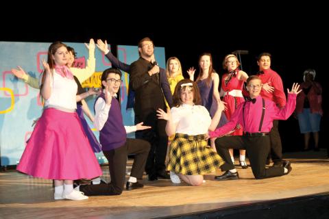 Columbia High School students performing in the school’s production of ‘Hairspray the Musical’ pause after completing a song. (TONY BRITT/Lake City Reporter)