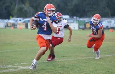 Branford quarterback Trent Land breaks into the open field against Wewahitchka last season. (FILE)
