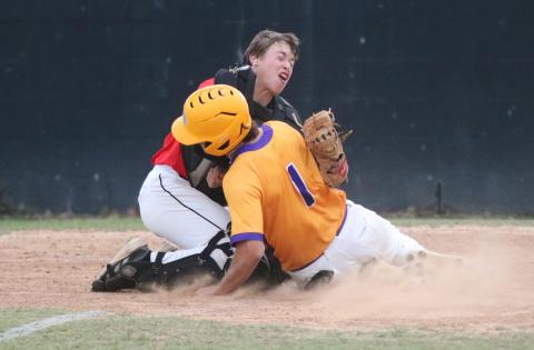 Columbia third baseman Goose Lord (1) is tagged out at home plate by Bishop Kenny catcher Timmy Pellicer on Wednesday night. (JORDAN KROEGER/Lake City Reporter)