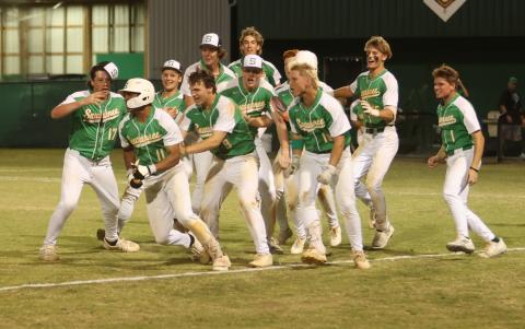 Suwannee shortstop Gabe Garcia (11) celebrates with teammates after hitting a three-RBI walk-off double to beat Columbia 8-7 in extra innings on Thursday. (PAUL BUCHANAN/Lake City Reporter)