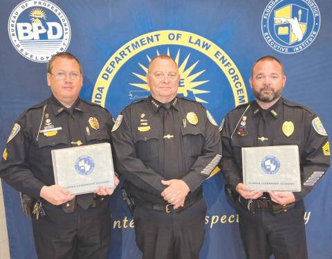 Lake City Police Sergeant Mike Lee (left) and First Sergeant Kevin Johns (right) stand with LCPD Chief Gerald Butler after earning their certificates at the Florida Leadership Academy. (COURTESY)