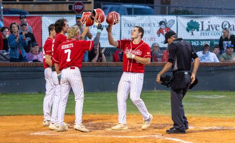 Lafayette's Trevor Byrd (right) taps helmets with teammates after hitting a three-run home run against Branford in Tuesday's District 6-R semifinal. (JACK HOWDESHELL/Lake City Reporter)