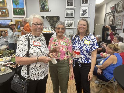 Susan Bell, secretary of the Live Oak Artists Guild (from left), Marilyn Jones, president, and Chris Flanagan, vice president, gather with attendees during the opening reception for the Guild’s exhibition at the Gateway Art Gallery in Lake City. (COURTESY)