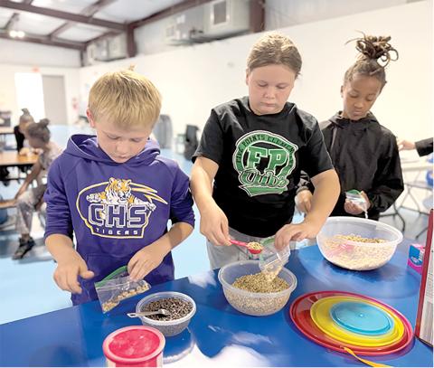 Third grade students at Niblack Elementary practice measuring by making their own trail mix through the nutrition lessons taught by UF/IFAS Extension Columbia County during PE classes at the school. (COURTESY UF/IFAS EXTENSION COLUMBIA COUNTY)