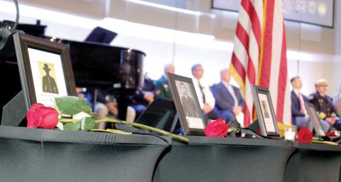 Roses, which were laid in honor of Columbia County first responders who lost their lives in the line of duty, rest on tables featuring the fallen first responder’s photo and patch representing the agency he worked for. The memorial service took place at Parkview Baptist Church on Tuesday afternoon. (TONY BRITT/Lake City Reporter)