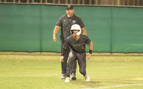 Suwannee center fielder Ty Moses takes a lead off third base while head coach Billy Moran looks on during the District 3-3A championship against Baldwin on April. 17. (PAUL BUCHANAN/Lake City Reporter)