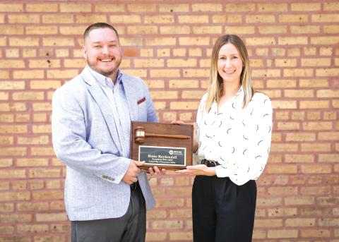Outgoing United Way of Suwannee Valley President Blake Kuykendall (left) is awarded a ceremonial gavel by President-Elect Lindsey Covington. (COURTESY)