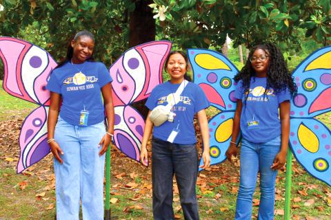 Members of the Suwannee High Key Club pose in front of a butterfly photo area at last year’s Wildflower Festival. (FILE)