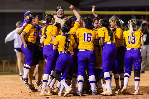 Columbia players celebrate in the circle after beating Baker County 6-2 to win the Region 1-4A title Thursday night. (JACK HOWDESHELL/Lake City Reporter)