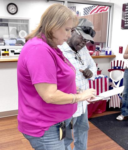 Suwannee County Supervisor of Elections Jennifer Kinsey shows Live Oak City Councilman Tommie Jefferson the vote totals from Tuesday’s city election. Jefferson advanced to a runoff election for the District 1 seat. (JAMIE WACHTER/Lake City Reporter)