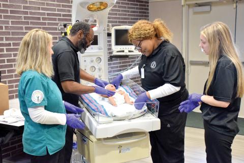 Nursing students at Florida Gateway College check on a doll who is on a radiant warmer donated to the school by the Lake Shore Hospital Authority. (COURTESY FLORIDA GATEWAY COLLEGE)