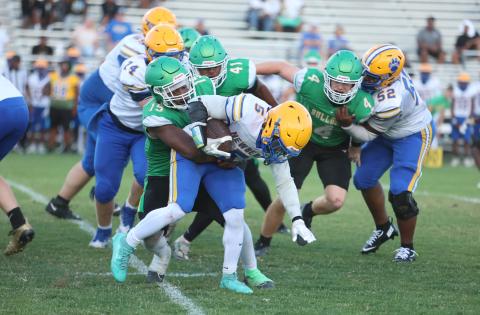Photos by PAUL BUCHANAN/Lake City Reporter Suwannee linebacker Marcos Rojas tries to bring down Newberry running back Jamarcus Wimberly during Friday’s spring game. 