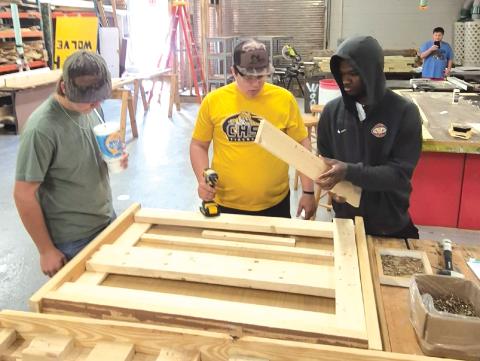 Mason Carrol (from left), Ashton Ambrose and Jordaeton Youmans work on making one of the beds for the local chapter of Sleep in Heavenly Peace. (COURTESY)