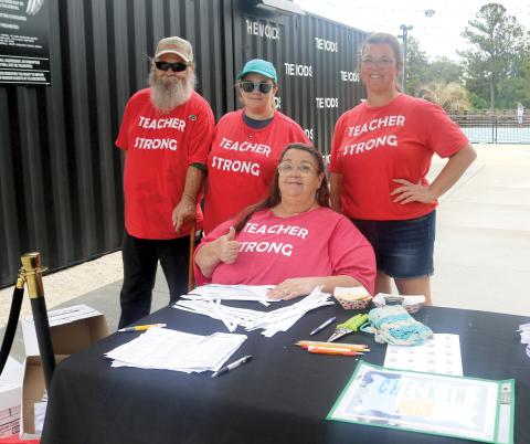 James Delaney (from left), Julia Jones, Jenee Delaney, president of the Columbia Teachers Association, and Kristen Smith, Columbia Teachers Association Executive Board member, pose for a picture while welcoming local educators to the 2026 Teacher Fête on Saturday at The Woods. (TONY BRITT/Lake City Reporter)
