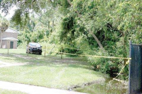 An area outside an apartment building is blocked off Tuesday afternoon following a fatal late-morning shooting outside an apartment building on NW Albright Place on the north side of Lake City. (MORGAN MCMULLEN/Lake City Reporter)