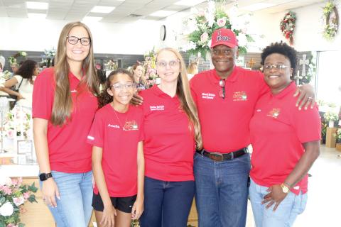 Lake City Florist family and owner/operators pose for a picture during the store’s grand re-opening on Thursday afternoon. Amanda Ivey (from left), Amelia Scott, Heather LeAnne McGuire, Ellsworth James McGuire Sr. and Briya McGuire. (TONY BRITT/Lake City Reporter)
