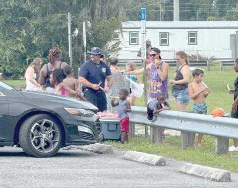 Lake City firefighter Earl Lupardus hands out popsicles to children at the Lake City Fire Department’s ‘Pop-Up Community Sparh Party’ at Annie Mattox Park on Friday. (COURTESY LAKE CITY FIRE DEPARTMENT)