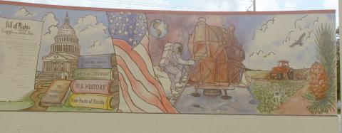 The mural by Cosby Hayes on the outside of the Columbia County Public Library’s West Branch detailing America’s history is now completed after Hayes added color to the various scenes from the past 250 years. (JAMIE WACHTER/Lake City Reporter)