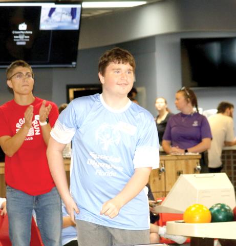 A Special Olympics Florida athlete from Columbia County looks down the lane as he releases a bowling ball during the Columbia County Special Olympics Bowling competition on Friday morning at Lake City Bowl. (TONY BRITT/Lake City Reporter)
