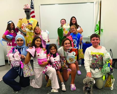 Campers pose with all of their completed projects next to the sewing mascot mannequin ‘Chad.’ (COURTESY UF/IFAS EXTENSION COLUMBIA COUNTY)