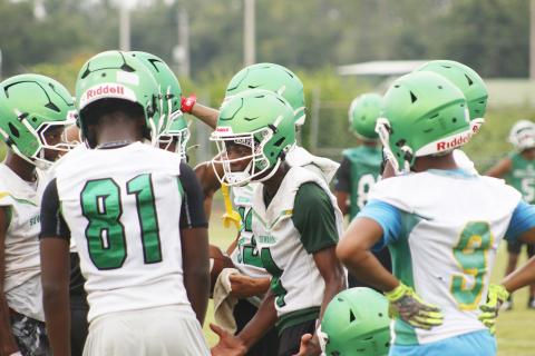 Suwannee receiver Kamari Lovett (center) demands better effort and results from his fellow teammates during 7-on-7 drills Monday. The Bulldogs’ offense had been dominated up until that point. (JAMIE WACHTER/Lake City Reporter)
