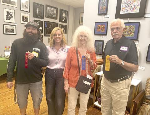 Taking the top prizes in the third annual Branford Camera Club Photography Exhibition and Competition were Georgia Schemetz (second from right), first place; Derek Linger (left), third place; and Rob Wolfe (right), honorable mention. Show coordinator Rachel Shelley is pictured with the winners. Not pictured are David Campione, who won second place, and Kathy Smith, who also captured an honorable mention. (COURTESY)