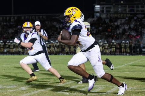 Columbia defensive end Jae’Quan Wilson races toward the end zone after scooping up an Oakleaf fumble Friday night while linebacker Bryson Grinstead looks on. Wilson scored on the play. (GARY LLOYD MCCULLOUGH/Special to the Reporter)