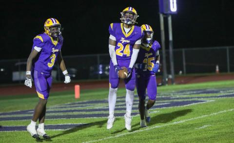 Columbia defensive end Jae’quan Wilson (24) celebrates with defensive back Montenrrence Williamson (3) and defensive back Chris Austin (15) after recovering a fumble for a touchdown against Madison County on Friday. (BRENT KUYKENDALL/Lake City Reporter)