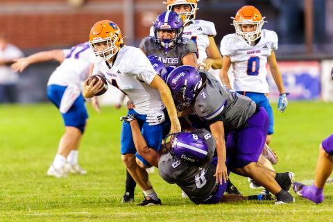 Branford quarterback Trent Land (4) gets tackled by a swarm of Bell defenders during Friday’s 27-14 loss. (JACK HOWDESHELL/Lake City Reporter)