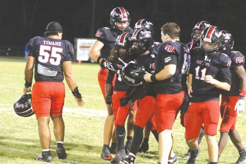 Fort White cornerback Jayton Walls is mobbed by teammates after his interception Friday against Taylor County. (MORGAN MCMULLEN/Lake City Reporter)