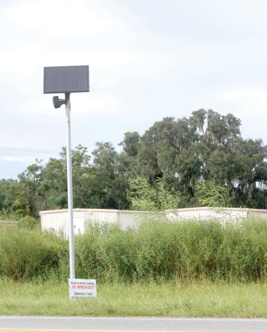 A Flock Safety camera sits along U.S. Highway 90 on the east side of Live Oak on Tuesday. (JAMIE WACHTER/Lake City Reporter)