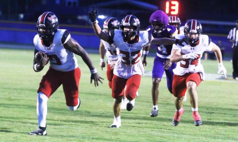 Fort White defensive tackle Josiah Harmon (9) returns a fumble for a touchdown as Bryce Bailey (32) celebrates during Friday’s win over Union County. (MORGAN MCMULLEN/Lake City Reporter)