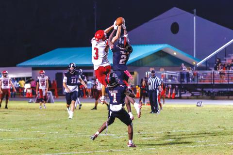 Fort White safety Marvion Wallace (2) picks off a pass intended for Lafayette’s Lane O’Steen before returning it for a touchdown Friday. (JACK HOWDESHELL/Lake City Reporter)