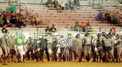 Suwannee head coach Kyler Hall and assistants PJ Davis, Kendrick Carter and Brian Wilder try to get the Bulldogs, including Jadayce Jones (13) to get away after a skirmish broke out late in the third quarter Friday against Zarephath Academy. Officials try to keep the Zarephath players separated. The game ended moments later when the Eagles decided to quit after having one player previously ejected as well. (PAUL BUCHANAN/Lake City Reporter)