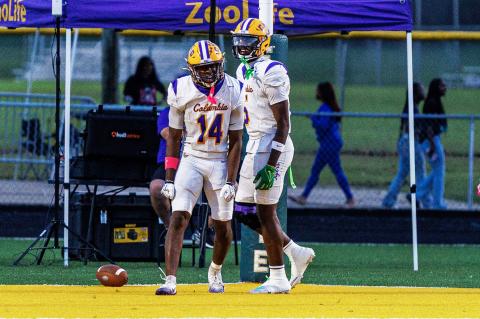 Columbia receiver Zion Walker (14) celebrates alongside Jaylon Willis after scoring on a 65-yard catch-and-run against Ed White on Friday. (JAMARION WEST/Special to the Reporter)