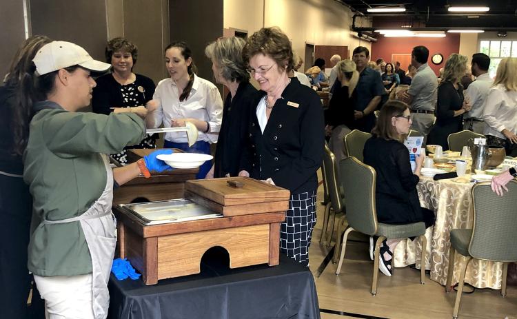 Attendees watch their bowls fill at the sixth annual Empty Bowls luncheon Nov. 8. The meal raised thousands of dollars for Barnabas Center’s programs that support Nassau County families in need.