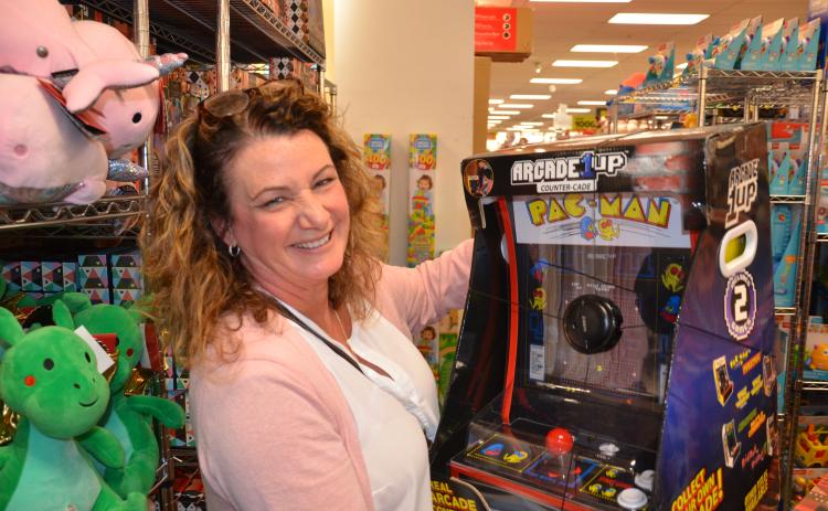 Bernadette Feickert eyes a miniature Pac-Man arcade machine at Belk on Friday morning. She wanted to get it for her 16-year-old, but imagined her two older sons would sneak turns on it, too. (CARL MCKINNEY/Lake City Reporter)