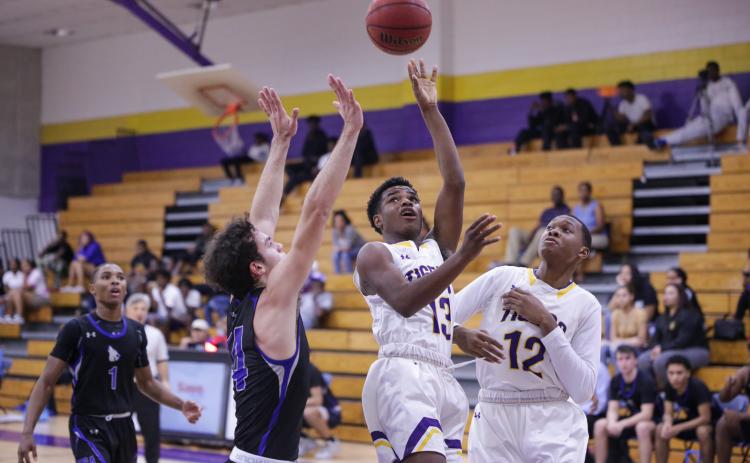 Columbia guard Tray Tolliver puts up a shot in traffic against Saint Francis Catholic on Tuesday night. (BRENT KUYKENDALL/Lake City Reporter)