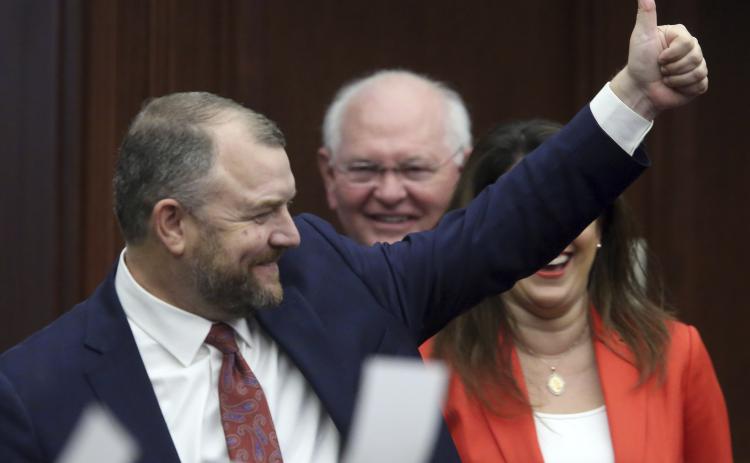 Sen. Rob Bradley, the Fleming Island Republican who represents Columbia County in the Legislature, gives a thumbs up as he leads the Senate committee to the House for the start of a joint session on Tuesday. (STEVE CANNON/Associated Press)