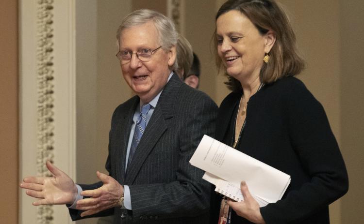 Senate Majority Leader Mitch McConnell, R-Ky., accompanied by his chief of staff, Sharon Soderstrom, after the Senate voted to not allow witnesses in the impeachment trial of President Donald Trump. (AP PHOTO)