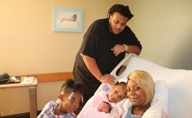 Sariyah Jones (from  left), Aniyah Jones, Alexander Jones and Kadijah Williams pose with Alexis Zakiyah Jones Thursday afternoon. Alexis Zakiyah, who came into the world Wednesday night, was the first baby born in Lake City in 2020. (TONY BRITT/Lake City Reporter)