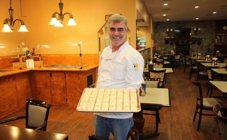 Abraham Farajian with a tray of baklava. (MICHAEL PHILIPS/Lake City Reporter)