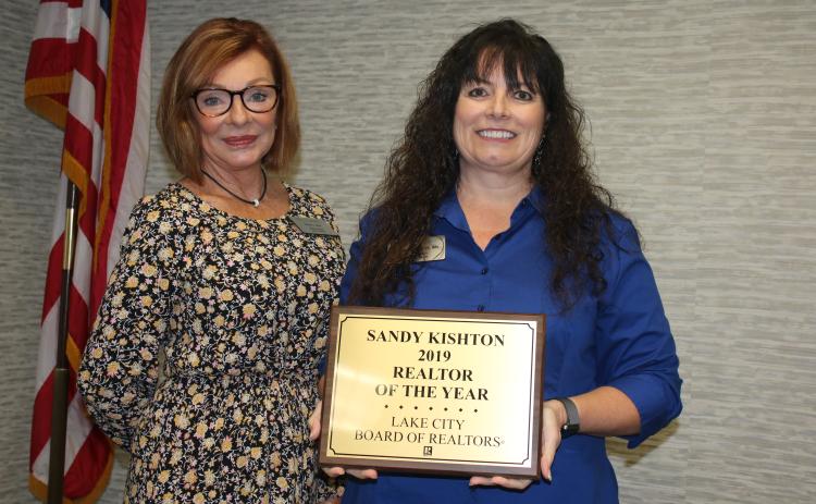 Susan Eagle (left), the 2020 Lake City Board of Realtors President, stands with Sandy Kishton after she presented Kishton with the 2019 Realtor of the Year Award during Monday’s Lake City Board of Realtors 2020 Installation Luncheon at the Lake City Holiday Inn. (TONY BRITT/Lake City Reporter)