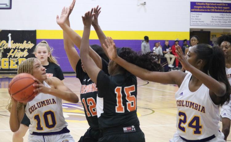 Columbia guard Taylor Ivery is swarmed by Hawthorne defenders during Thursday night’s game. (ZACH ABOLVERDI/Lake City Reporter)