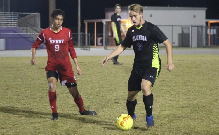 Columbia’s Jakob North dribbles the ball up the field as Bishop Kenny’s Martin Pineiros rushes to defend. (ZACH ABOLVERDI/Lake City Reporter)